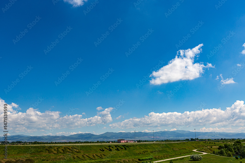 Grass field and blue sky in sunny day