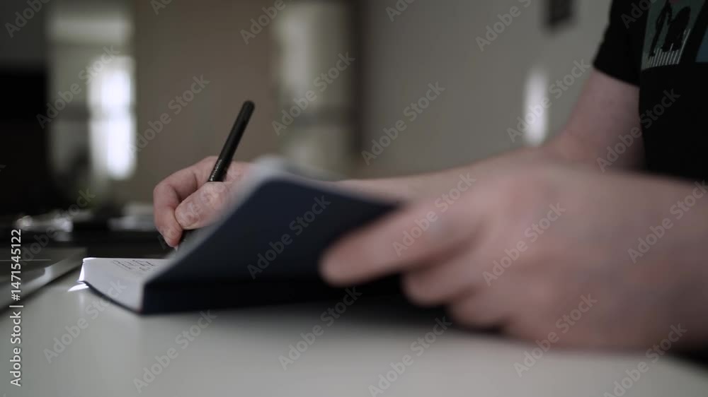 Man Journaling - Focused Handwriting in a Notebook to Self-Help During Depression Man Journaling - Focused Handwriting in a Notebook to Self-Help During Depression