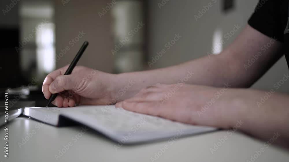 Man Journaling - Focused Handwriting in a Notebook to Self-Help During Depression Man Journaling - Focused Handwriting in a Notebook to Self-Help During Depression
