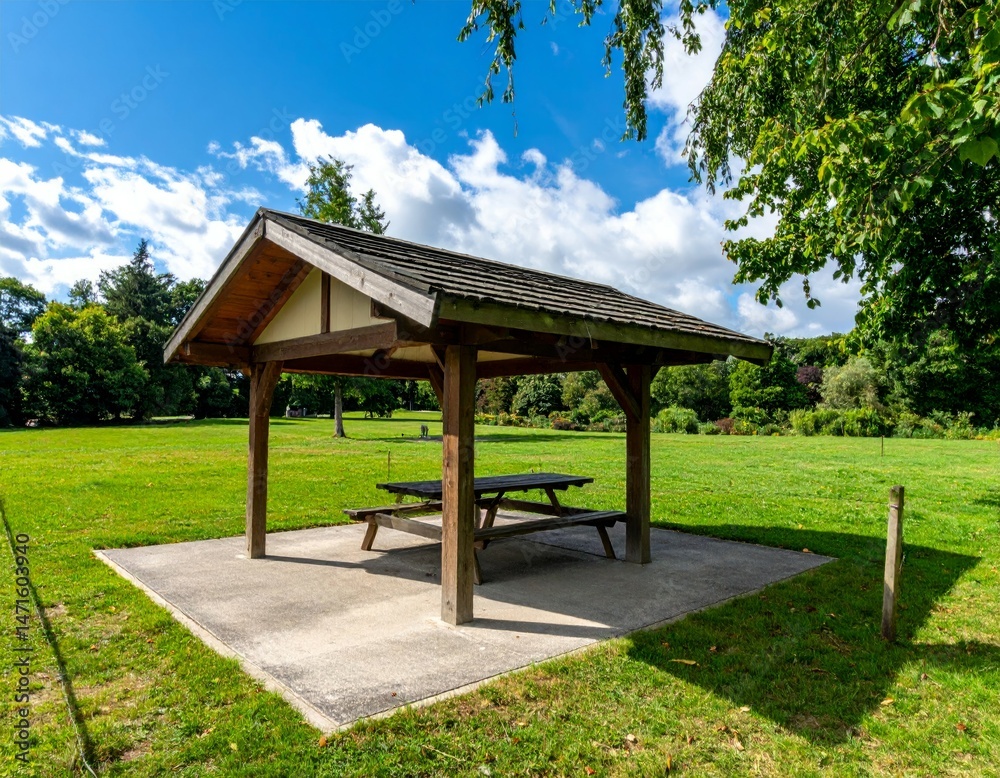 Serene Picnic Shelter in a Lush Green Park Under Clear Blue Sky Serene Picnic Shelter in a Lush Green Park Under Clear Blue Sky
