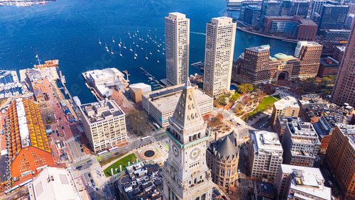 Two similar Harbor towers in Boston, Massachusetts, USA. City tallest buildings at the backdrop of blue waterscape. Aerial view.