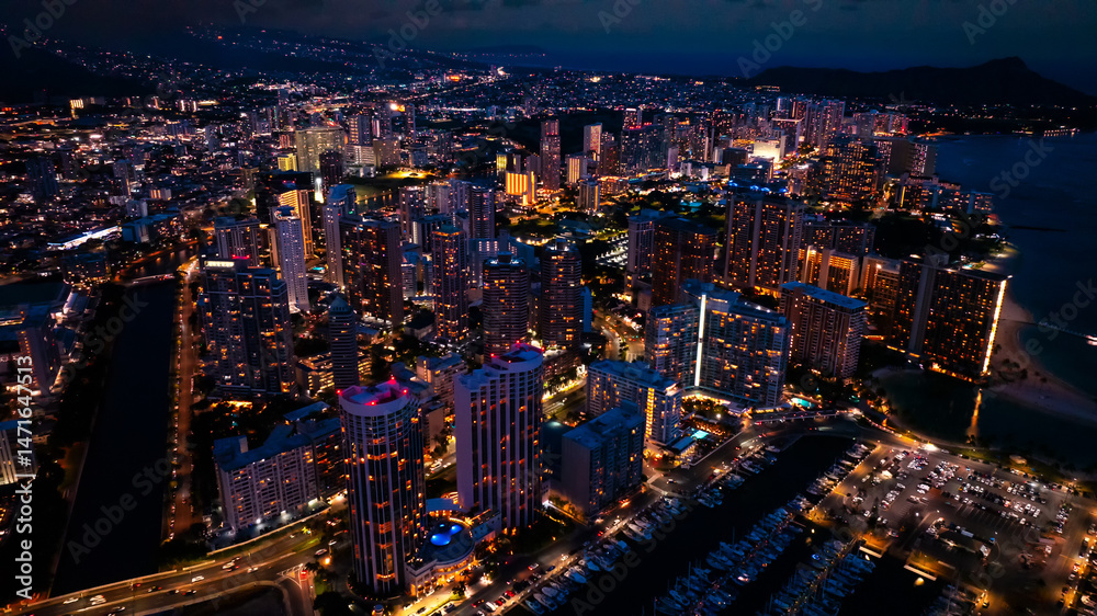 Obraz premium Scenic view on the night Waikiki. Fantastically illuminated cityscape at dusk. Aerial view.