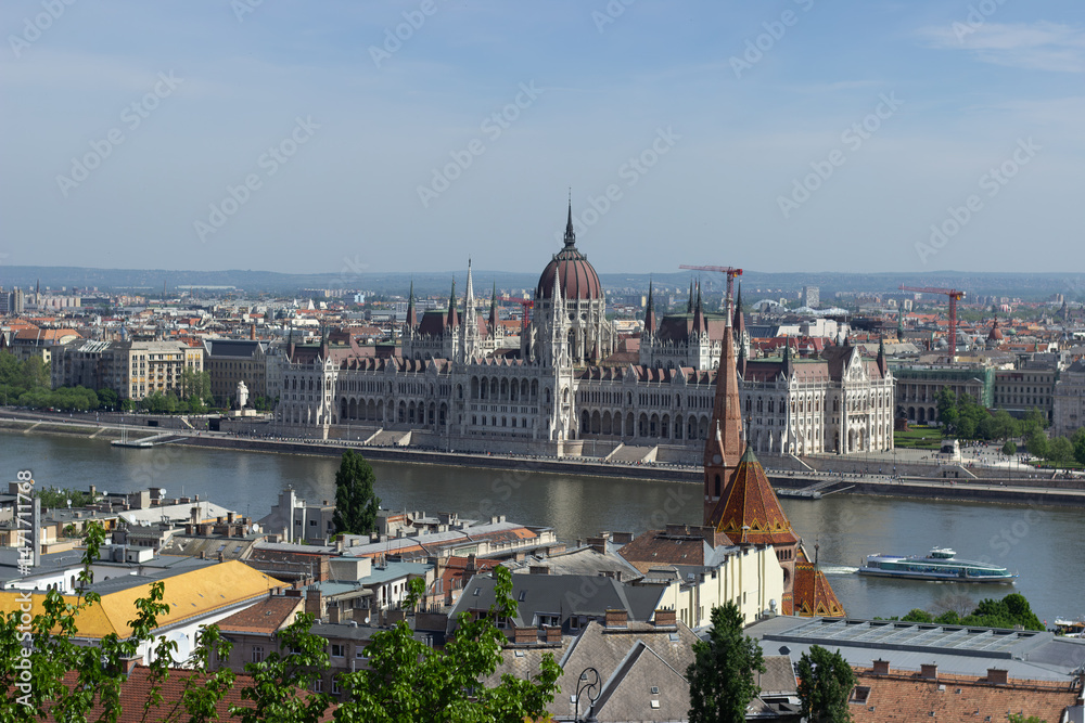 Fototapeta premium Panoramic view of Budapest city with Parliament building, Danube River, bridges and green trees under clear blue sky