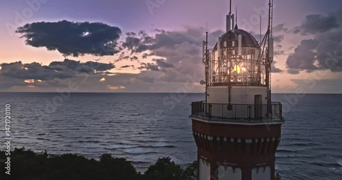 Light from lighthouse after sunsed by Baltic Sea in summer.
