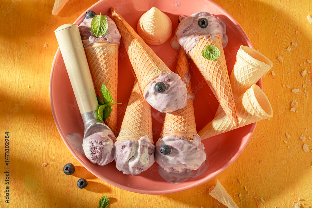 Tasty and fresh blueberry ice cream in a waffle cone.