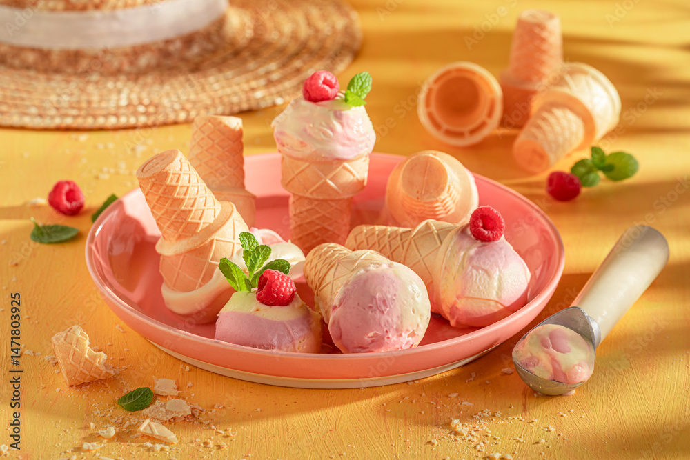 Fresh and homemade raspberry ice cream made of red berries.