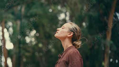 Woman raising her arms and embracing nature