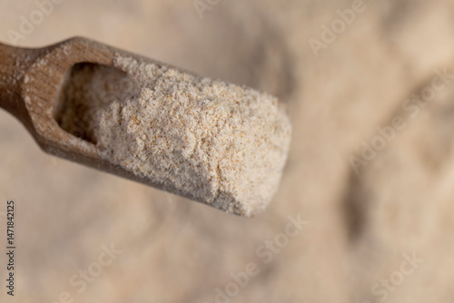 wheat flour for making bread with bran. flour in a spoon close up