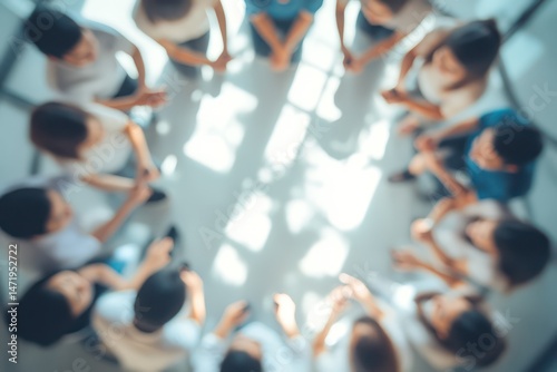 Blurred overhead view of group meeting in modern office