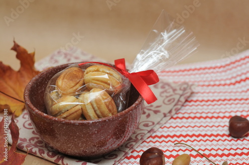 nut-like cookies in a brown ceramic pot.