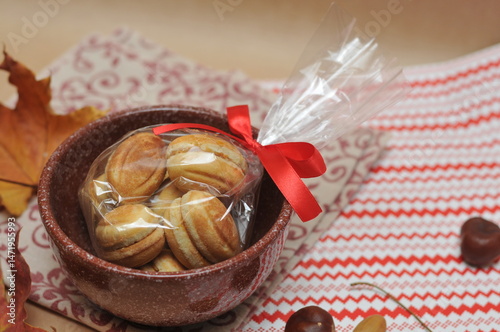 cookies tied with a bow in a brown ceramic pot.