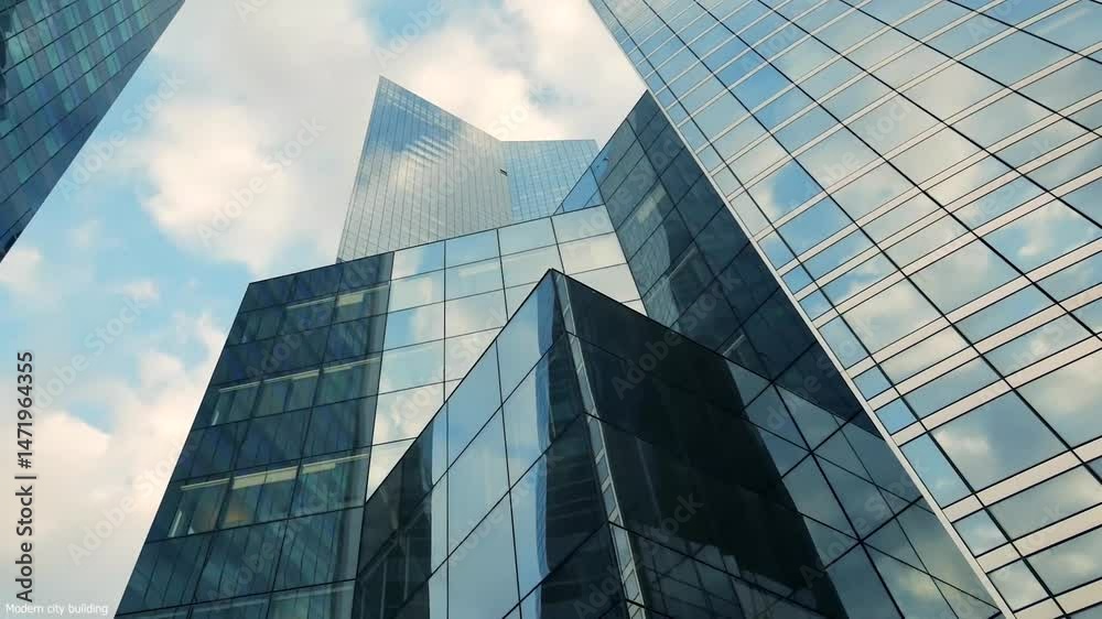 Modern Corporate Buildings with Glassed office building exterior with sky reflection in the windows.