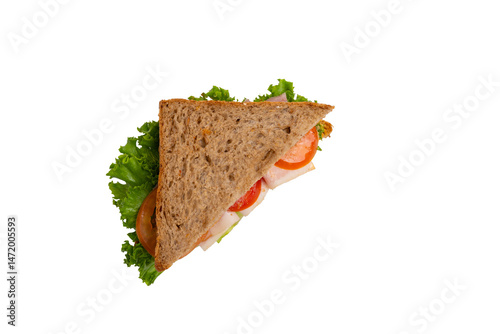 A ham sandwich with lettuce, tomato, and ham on whole-wheat bread is isolated on a white background.