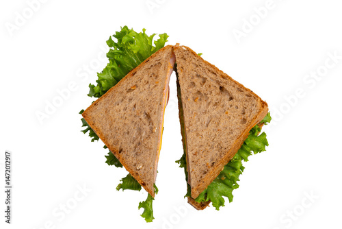 Two ham sandwiches with lettuce, tomato, and ham on whole-wheat bread are isolated on a white background.