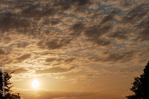 Sun and cloudy sky at sunset in spring