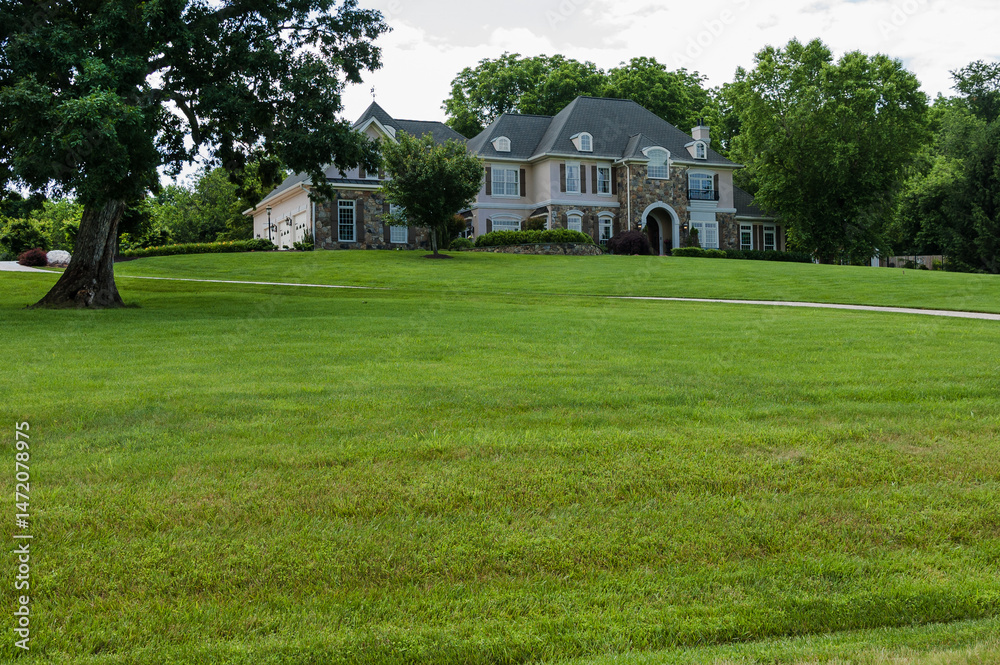 Fototapeta premium Gorgeous landscape with single family home and green lawn. Country house in Virginia.