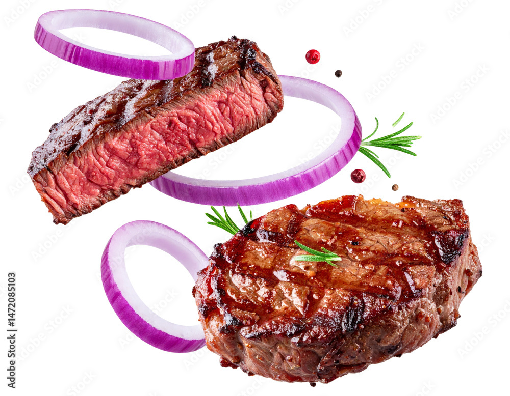 Juicy Beef Steak with Onion Rings and Rosemary Isolated on Black Background