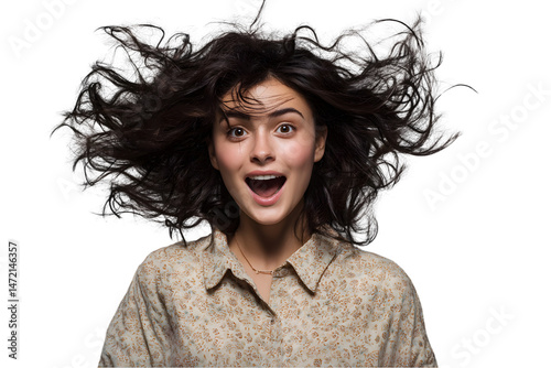 Surprised young woman with long brown hair blowing in the wind studio shot happy excited girl on transparent background