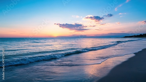 Serene sunset over a tranquil ocean beach, soft waves gently lapping the shore, pastel pink and blue sky. : Generative AI