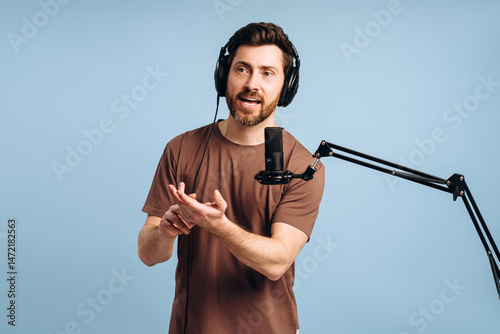 Fotografie Content creator recording podcast wearing headphones and speaking into microphon