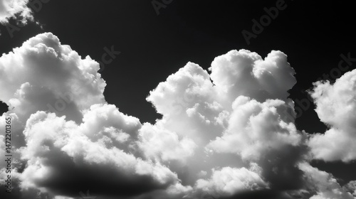 Dramatic black and white image of fluffy cumulus clouds against a dark sky, creating a striking contrast and texture. : Generative AI
