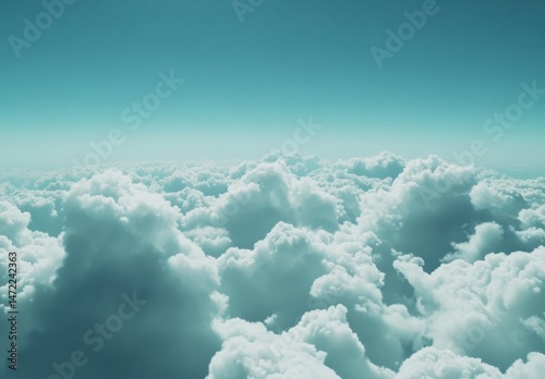 A breathtaking aerial view of a vast expanse of cumulus clouds, bathed in a serene teal light, stretching to a clear, bright horizon. : Generative AI