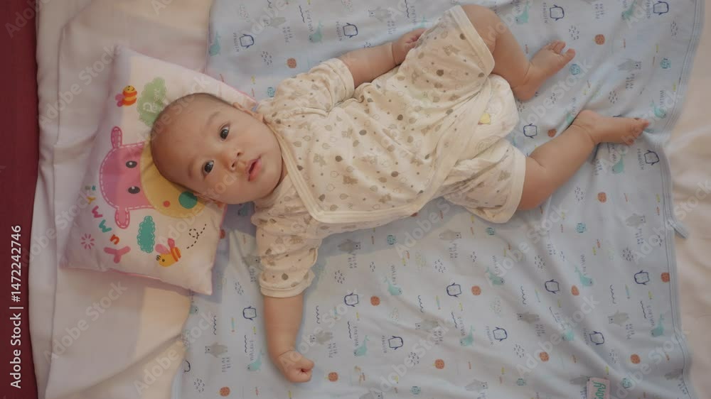 A charming baby resting on a cozy bed with a soft, playful pillow. The gentle expressions and serene setting create a warm atmosphere, perfect for capturing the innocence of early childhood. A charming baby resting on a cozy bed with a soft, playful pillow. The gentle expressions and serene setting create a warm atmosphere, perfect for capturing the innocence of early childhood.