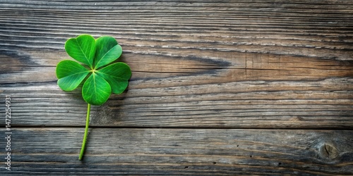 Rustic Wooden Background Featuring a Vibrant Green Four-Leaf Clover