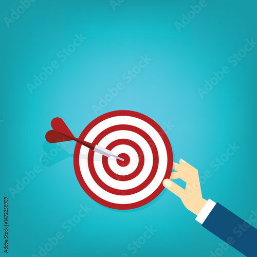 Hand holding a target, showing a goal. Red arrow hits the center. Business challenge failure and success concept.