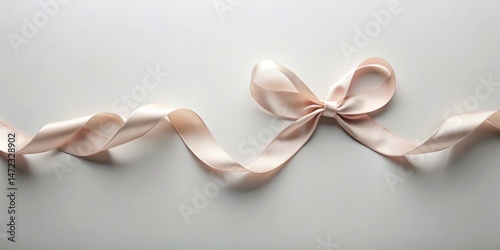Elegant blush pink satin ribbon tied in a bow with flowing tails on a neutral background