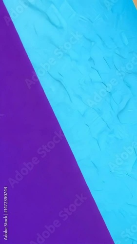 Textured turquoise surface with geometric patterns. Background shifts from purple to turquoise to wooden tones across aqua-blue material.