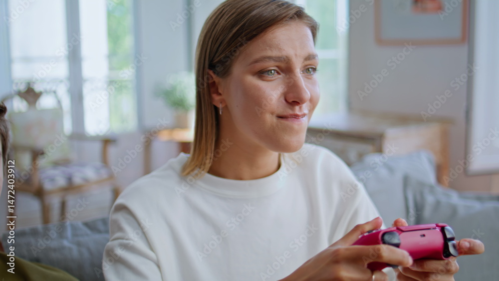 Nervous teen using gamepad for online game at house closeup. Happy woman player
