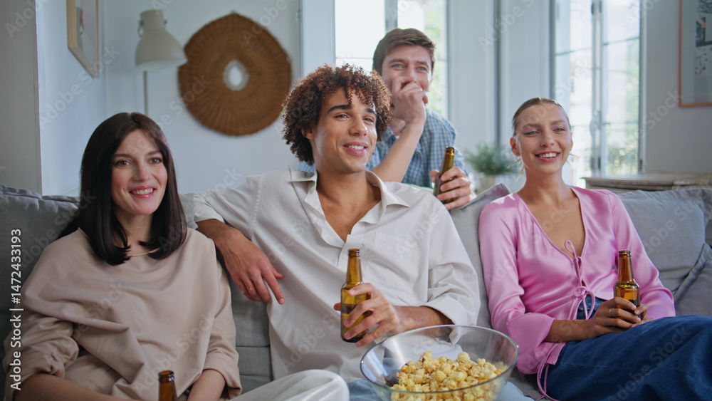 Happy millennials drinking beer at weekend gathering closeup. Friends talking
