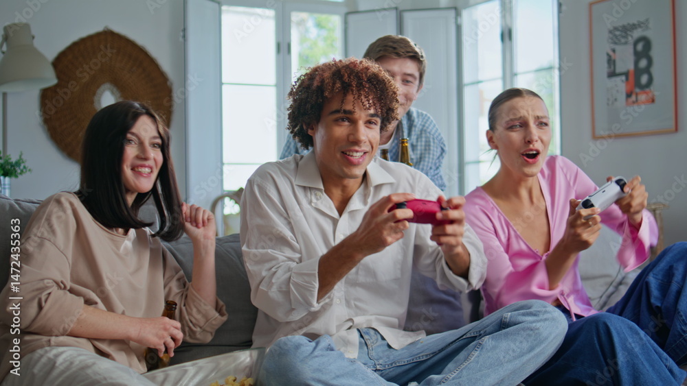 Competitive players enjoy video game at apartment sofa closeup. People playing