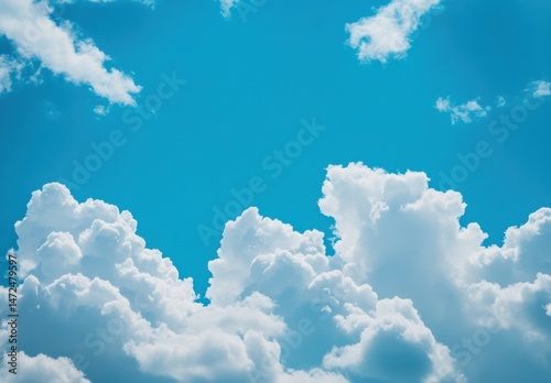 A vibrant blue sky filled with fluffy cumulus clouds, creating a serene and peaceful atmosphere.  The clouds are brilliantly white against the deep blue canvas, offering a stunning nat : Generative AI