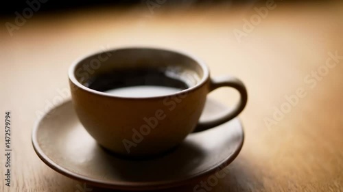Close-Up of Freshly Brewed Coffee Cup with Rising Steam on Wooden Table