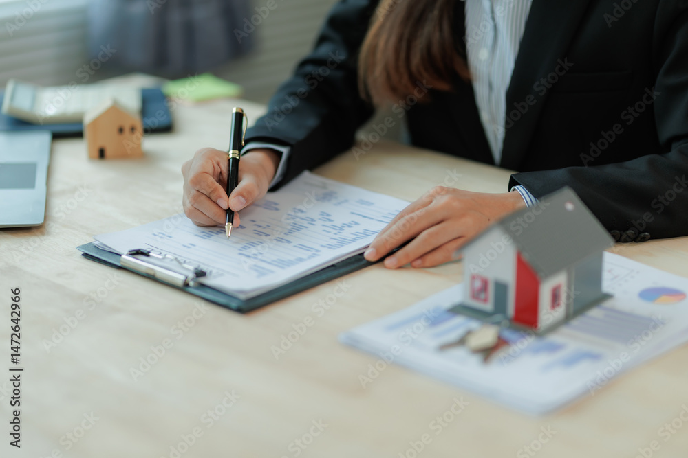 © Wanchai - A business agent discusses property or financial plans with a client, highlighting trust, protection, and family security through symbols like keys, contracts, and unity.