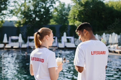 Lifeguards supervising swimming pool on a sunny day