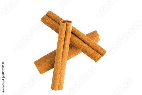 Fototapeta Naklejka Na Ścianę i Meble -  Flat lay of cinnamon bark shards on white, emphasizing their organic forms and warm brown coloration.