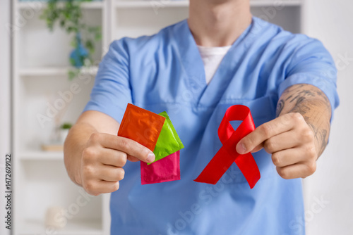 Young doctor showing condom...