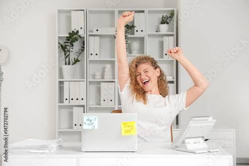 Happy young businesswoman u...