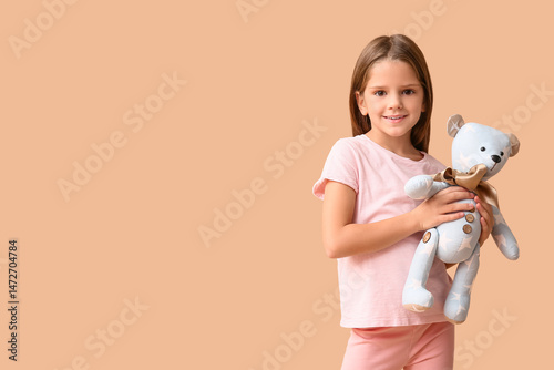 Happy little girl with tedd...