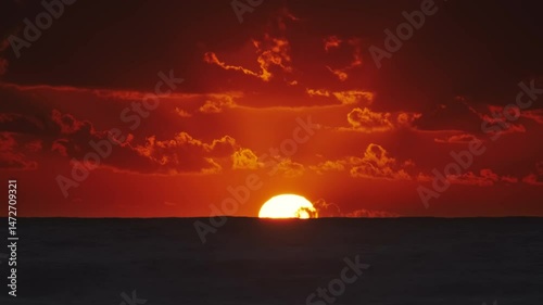 Vibrant sunset over ocean with dramatic clouds at dusk, timelapse 4k