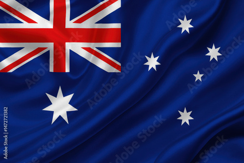 Australian flag with wavy silk folds, close-up view, fabric texture visible, national identity symbol on a neutral background.