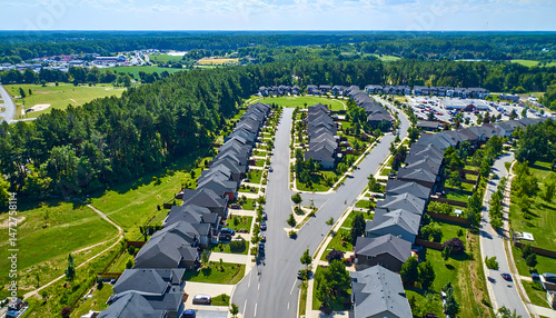Aerial view of a suburban neighborhood featuring well-maintained homes and lush green parks
