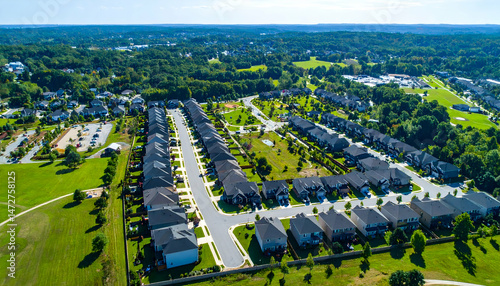 Aerial view of a suburban neighborhood showcasing houses, green parks, and recreational areas (1)