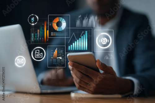 Businessman analyzing digital data dashboard with charts and graphs on smartphone and laptop
