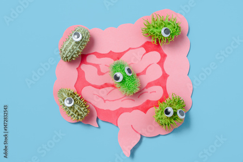 Googly-Eyed Microbes Gather Around Cutout Intestines