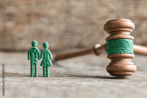 Legal separation concept. A couple stands before a judge's gavel, symbolizing the legal proceedings of separation and divorce with a fair judgement. photo