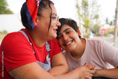 Hispanic mother and son sharing a tender moment on mother's day